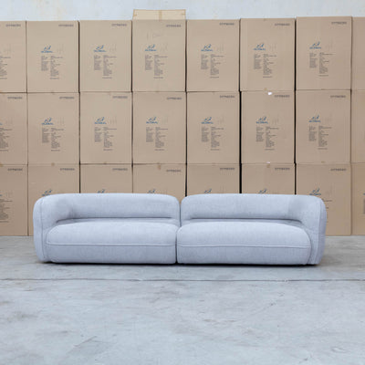 The Harper Curved Fabric Four Seat Sofa - Pewter available to purchase from Warehouse Furniture Clearance at our next sale event.