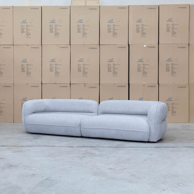The Harper Curved Fabric Four Seat Sofa - Pewter available to purchase from Warehouse Furniture Clearance at our next sale event.