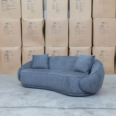 The Noosa Curved Fabric Three Seat Sofa - Dark Grey available to purchase from Warehouse Furniture Clearance at our next sale event.