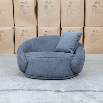 The Noosa Curved Fabric Armchair - Dark Grey available to purchase from Warehouse Furniture Clearance at our next sale event.