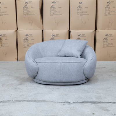 The Noosa Curved Fabric Armchair - Light Grey available to purchase from Warehouse Furniture Clearance at our next sale event.
