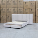 The Isla Queen Upholstered Storage Bed Extended Headboard - Oat White available to purchase from Warehouse Furniture Clearance at our next sale event.