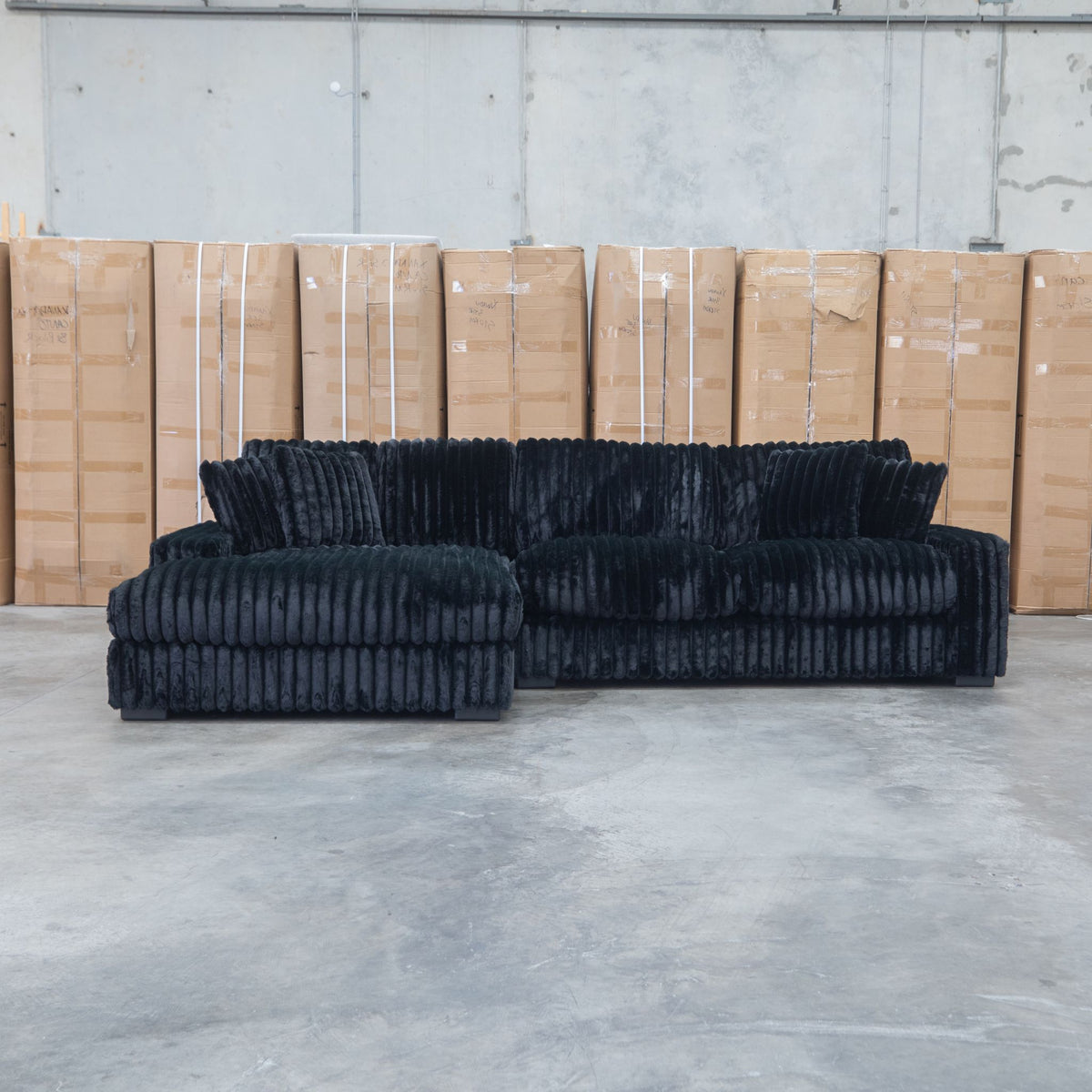 The Kalena Oversized Plush Feather & Foam LHF Chaise Lounge - Black available to purchase from Warehouse Furniture Clearance at our next sale event.
