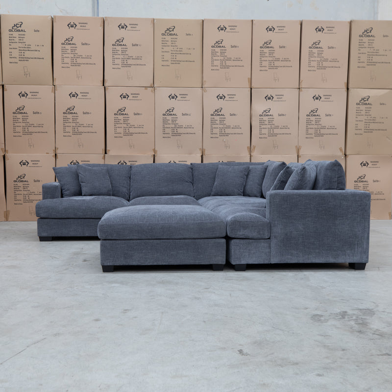 The Ashland Deep Seated Feather & Foam Corner Lounge with Ottoman - Licorice available to purchase from Warehouse Furniture Clearance at our next sale event.