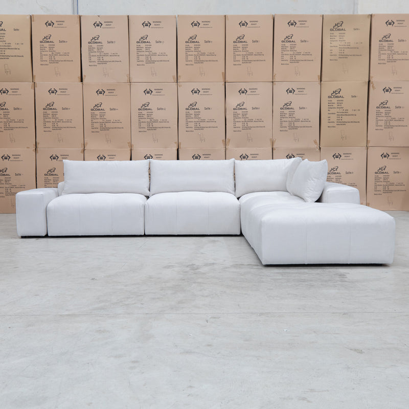 The Barles Modular Corner Lounge with Ottoman - Oat White available to purchase from Warehouse Furniture Clearance at our next sale event.