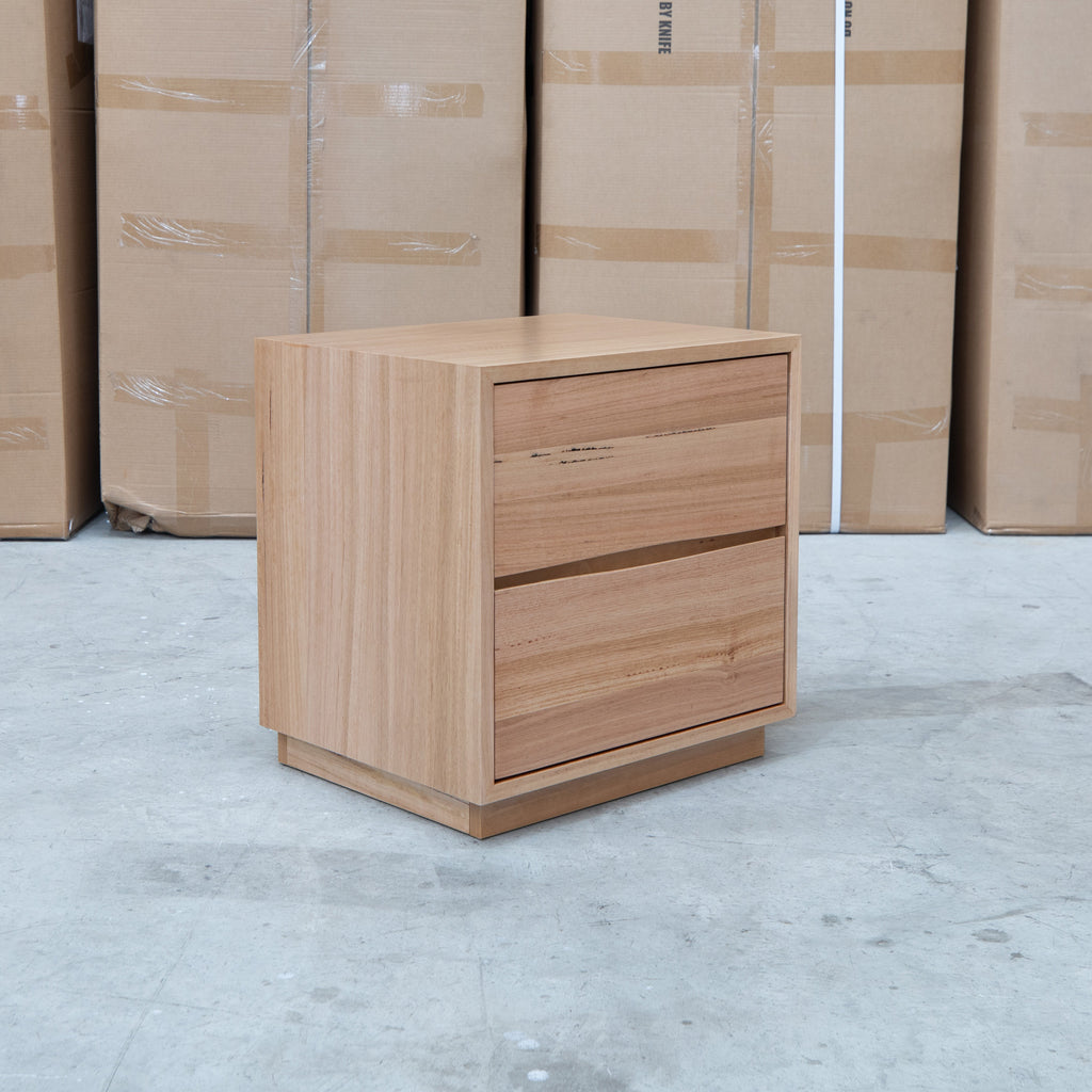 The Lana Two Drawer Australian Messmate Hardwood Bedside available to purchase from Warehouse Furniture Clearance at our next sale event.