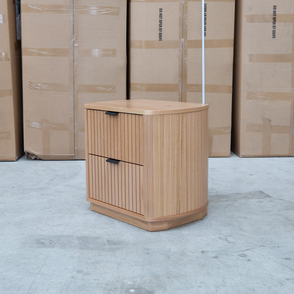 The Bentley Curved Two Drawer Australian Messmate Hardwood Bedside available to purchase from Warehouse Furniture Clearance at our next sale event.
