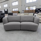 The COR-13033 2.5 seat curved sofa - Light Grey - Floor Stock available to purchase from Warehouse Furniture Clearance at our next sale event.