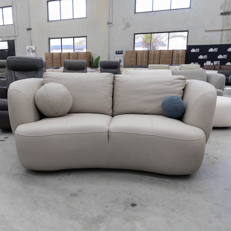 The COR-13033 2 seat leather curved sofa - Oatmeal - Floor Stock available to purchase from Warehouse Furniture Clearance at our next sale event.