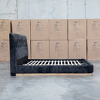 The Clara King Upholstered Bed with Solid Timber Plinth - Black available to purchase from Warehouse Furniture Clearance at our next sale event.