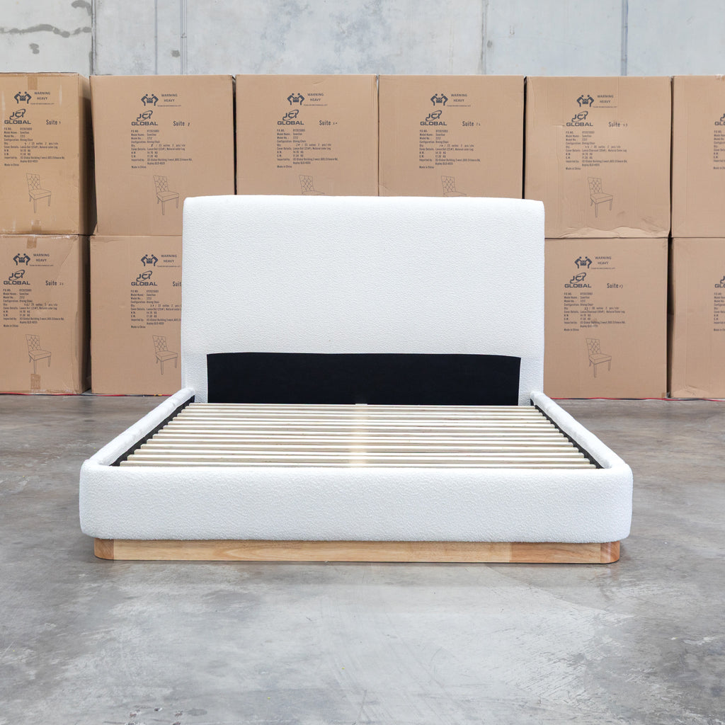 The Clara King Upholstered Bed with Solid Timber Plinth - Cream available to purchase from Warehouse Furniture Clearance at our next sale event.