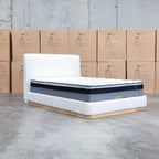 The Clara King Upholstered Bed with Solid Timber Plinth - Cream available to purchase from Warehouse Furniture Clearance at our next sale event.