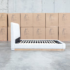 The Clara King Upholstered Bed with Solid Timber Plinth - Cream available to purchase from Warehouse Furniture Clearance at our next sale event.