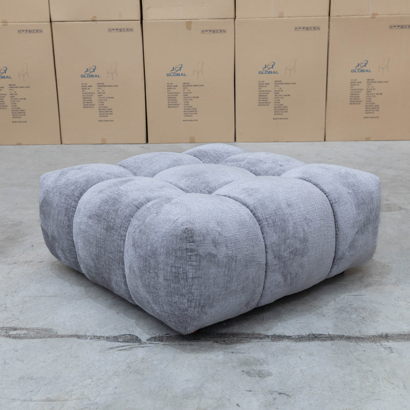 The Cloud Plush Fabric Ottoman - Slate available to purchase from Warehouse Furniture Clearance at our next sale event.