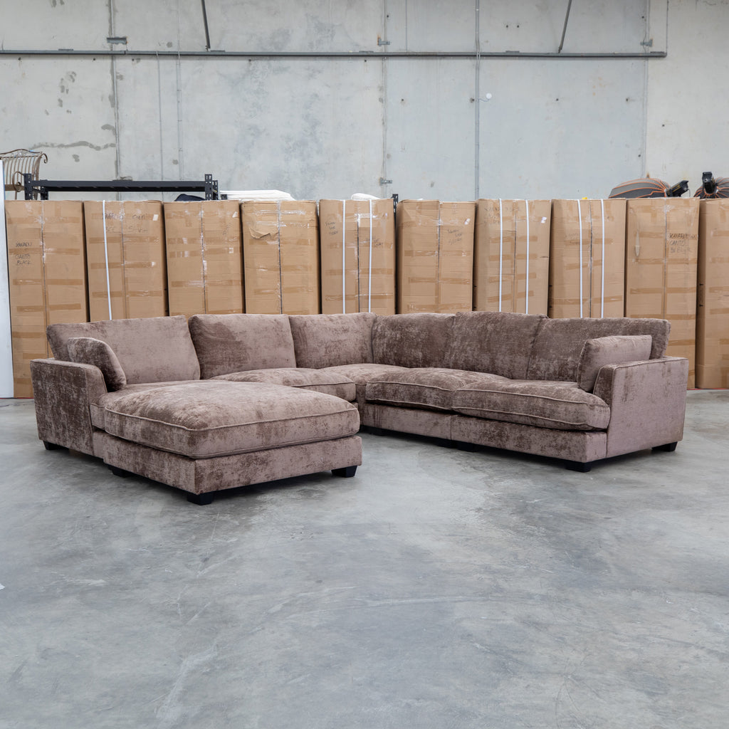 The Veloura Feather & Foam Corner Suite with Ottoman - Fiona Chocolate available to purchase from Warehouse Furniture Clearance at our next sale event.