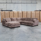 The Veloura Feather & Foam Corner Suite with Ottoman - Fiona Chocolate available to purchase from Warehouse Furniture Clearance at our next sale event.