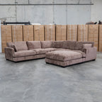 The Veloura Feather & Foam Corner Suite with Ottoman - Fiona Chocolate available to purchase from Warehouse Furniture Clearance at our next sale event.
