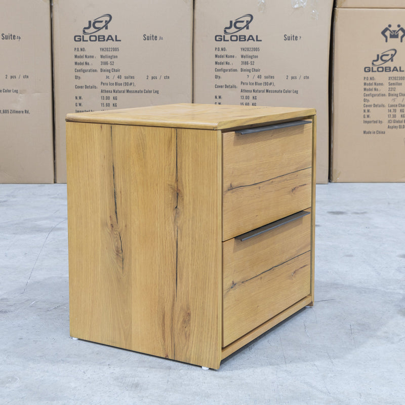 The Newfarm Distressed Oak Two Drawer Hardwood Bedside available to purchase from Warehouse Furniture Clearance at our next sale event.