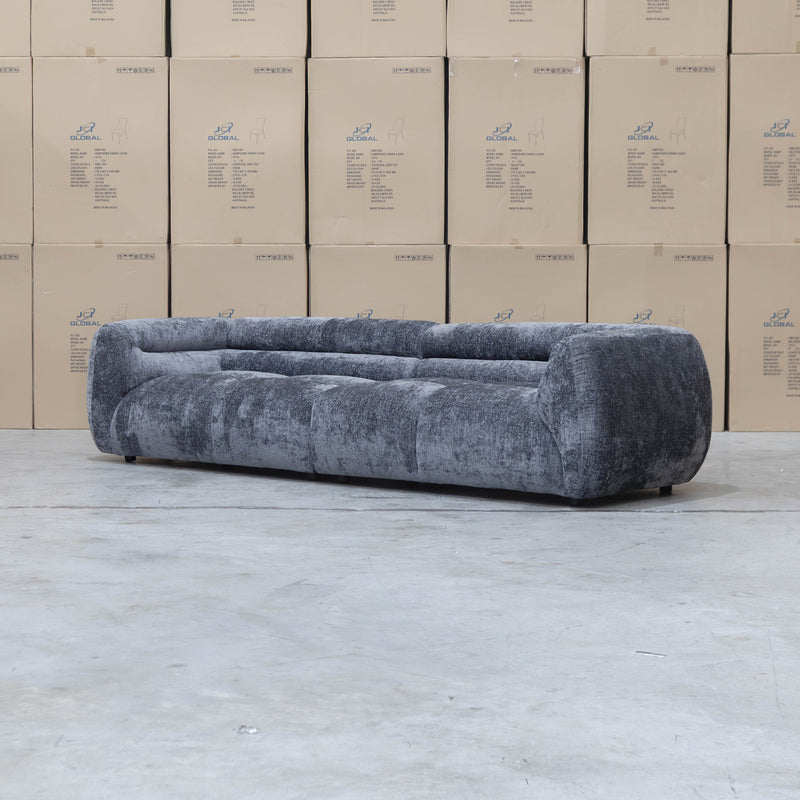 The Fara Curved Fabric Four Seat Sofa - Steel available to purchase from Warehouse Furniture Clearance at our next sale event.