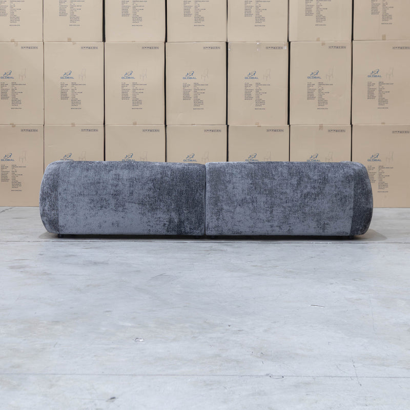 The Fara Curved Fabric Four Seat Sofa - Steel available to purchase from Warehouse Furniture Clearance at our next sale event.