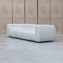 The Fara Curved Fabric Four Seat Sofa - Cloud available to purchase from Warehouse Furniture Clearance at our next sale event.