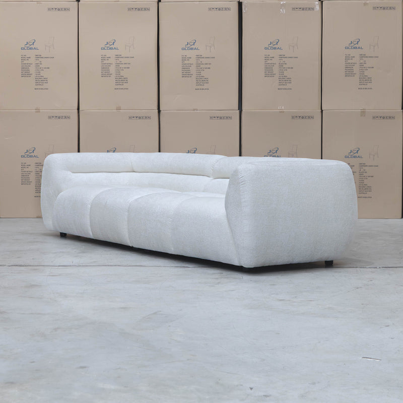 The Fara Curved Fabric Four Seat Sofa - Cloud available to purchase from Warehouse Furniture Clearance at our next sale event.