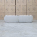 The Fara Curved Fabric Four Seat Sofa - Cloud available to purchase from Warehouse Furniture Clearance at our next sale event.