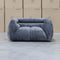 The Fara Curved Fabric Armchair - Steel available to purchase from Warehouse Furniture Clearance at our next sale event.