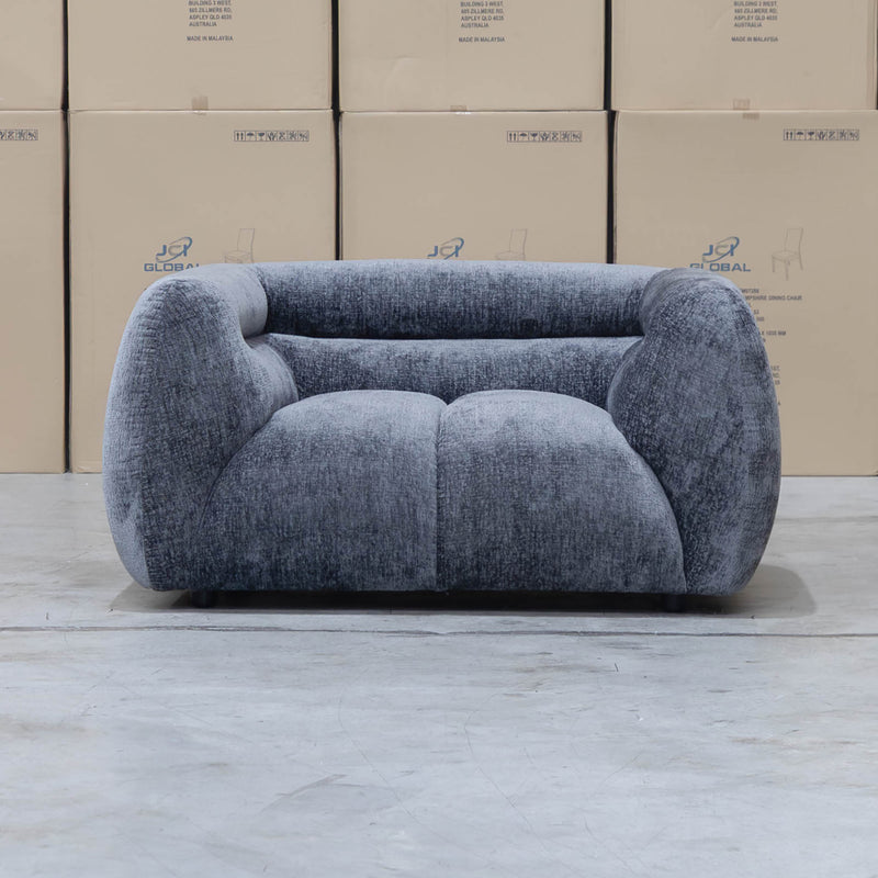 The Fara Curved Fabric Armchair - Steel available to purchase from Warehouse Furniture Clearance at our next sale event.