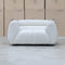 The Fara Curved Fabric Armchair - Cloud available to purchase from Warehouse Furniture Clearance at our next sale event.