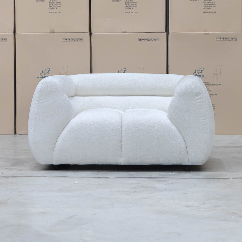 The Fara Curved Fabric Armchair - Cloud available to purchase from Warehouse Furniture Clearance at our next sale event.