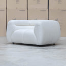 The Fara Curved Fabric Armchair - Cloud available to purchase from Warehouse Furniture Clearance at our next sale event.