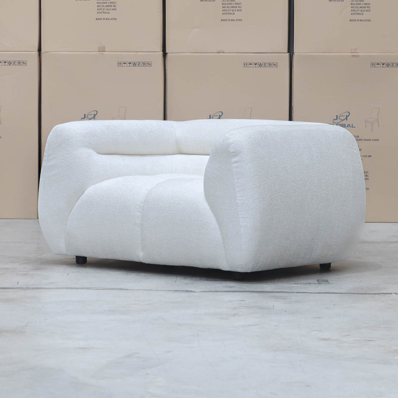 The Fara Curved Fabric Armchair - Cloud available to purchase from Warehouse Furniture Clearance at our next sale event.