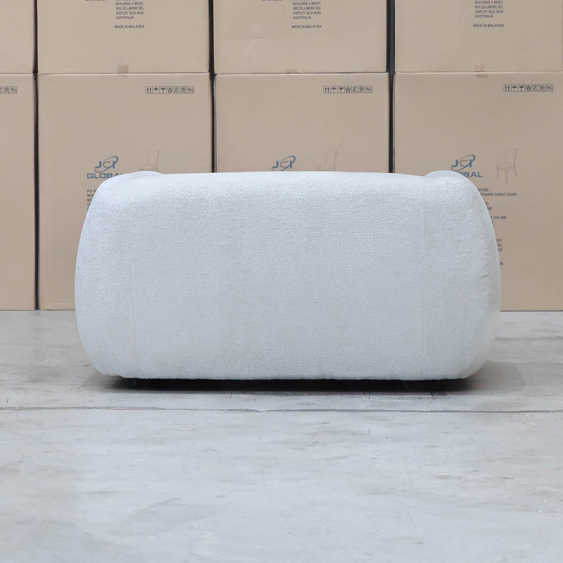 The Fara Curved Fabric Armchair - Cloud available to purchase from Warehouse Furniture Clearance at our next sale event.