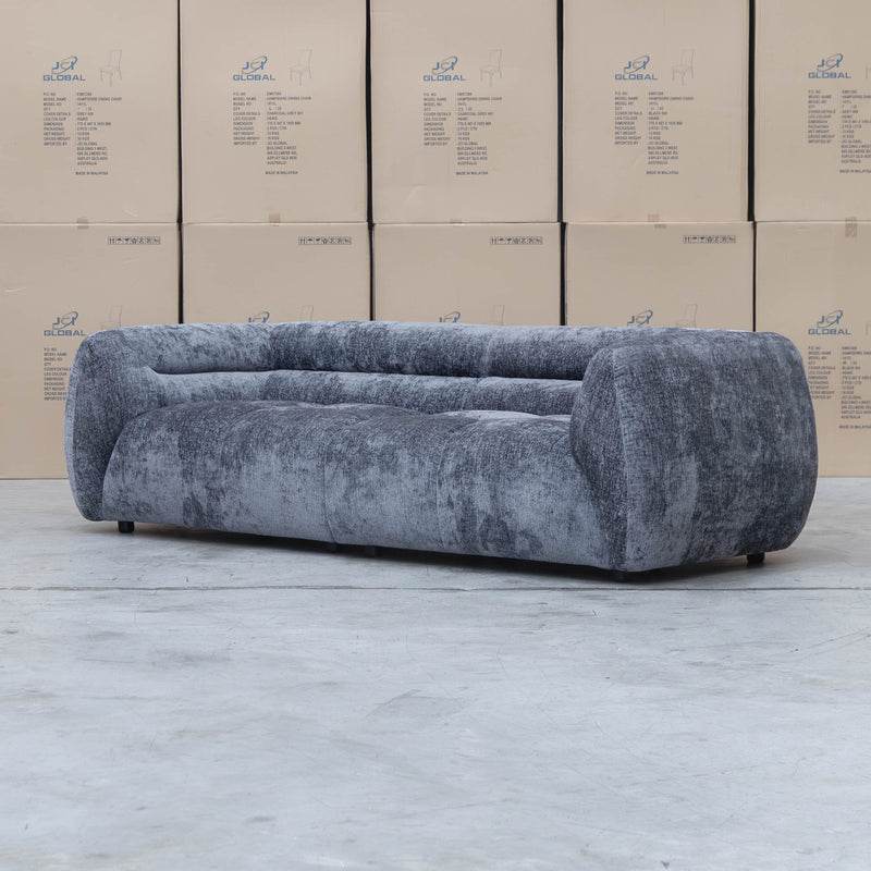 The Fara Curved Fabric Three Seat Sofa - Steel available to purchase from Warehouse Furniture Clearance at our next sale event.