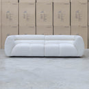 The Fara Curved Fabric Three Seat Sofa - Cloud available to purchase from Warehouse Furniture Clearance at our next sale event.