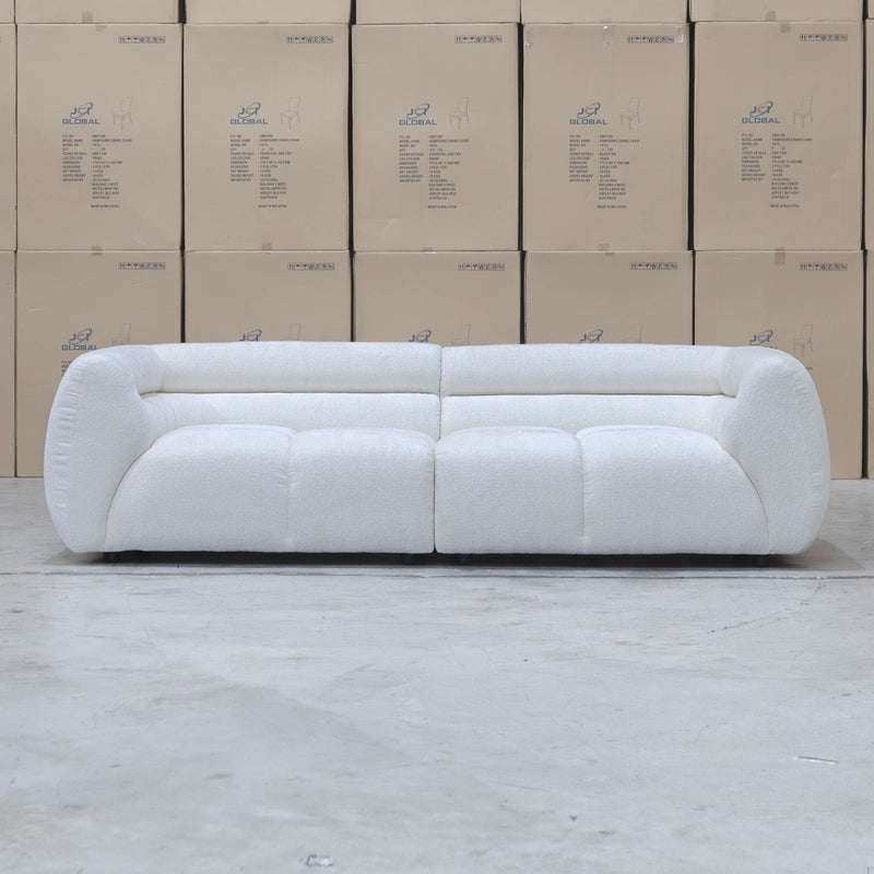 The Fara Curved Fabric Three Seat Sofa - Cloud available to purchase from Warehouse Furniture Clearance at our next sale event.