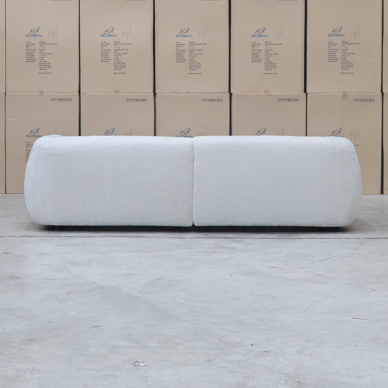 The Fara Curved Fabric Three Seat Sofa - Cloud available to purchase from Warehouse Furniture Clearance at our next sale event.