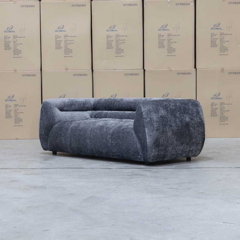 The Fara Curved Fabric Two Seat Sofa - Steel available to purchase from Warehouse Furniture Clearance at our next sale event.