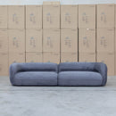 The Harper Curved Fabric Four Seat Sofa - Charcoal available to purchase from Warehouse Furniture Clearance at our next sale event.