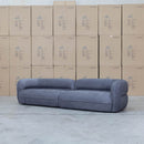 The Harper Curved Fabric Four Seat Sofa - Charcoal available to purchase from Warehouse Furniture Clearance at our next sale event.