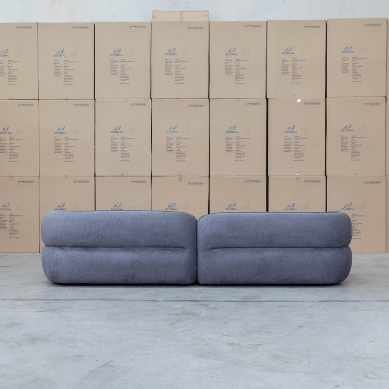 The Harper Curved Fabric Four Seat Sofa - Charcoal available to purchase from Warehouse Furniture Clearance at our next sale event.