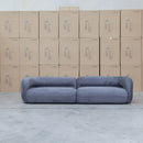 The Harper Curved Fabric Four Seat Sofa - Charcoal available to purchase from Warehouse Furniture Clearance at our next sale event.