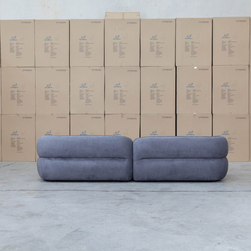 The Harper Curved Fabric Four Seat Sofa - Charcoal available to purchase from Warehouse Furniture Clearance at our next sale event.