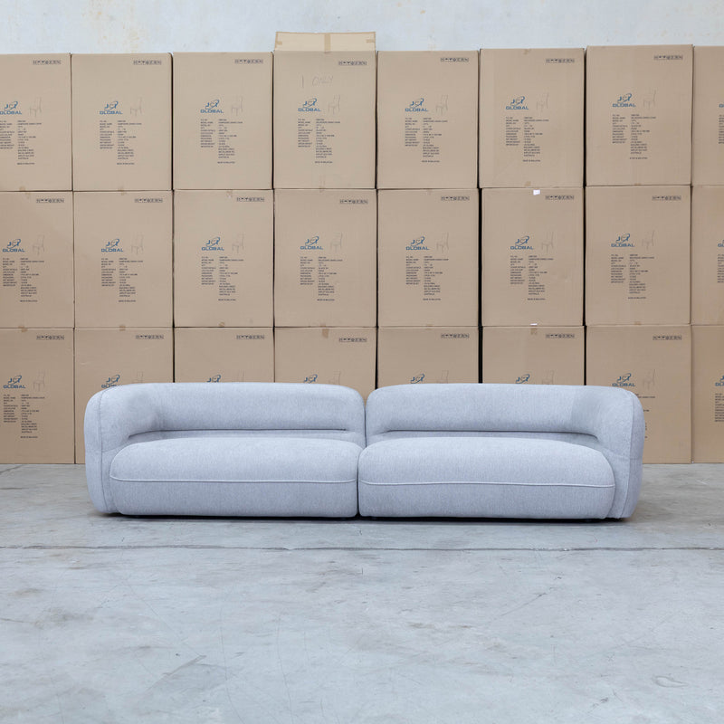 The Harper Curved Fabric Four Seat Sofa - Pewter available to purchase from Warehouse Furniture Clearance at our next sale event.