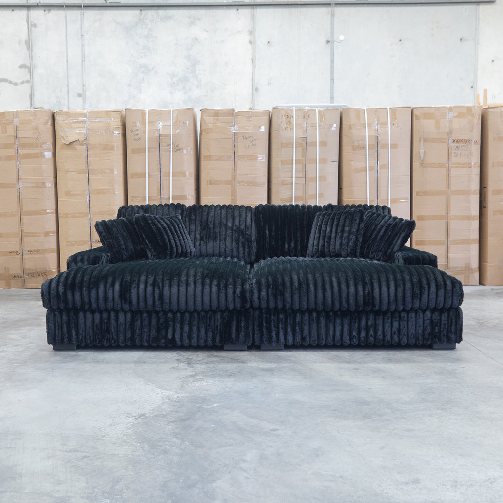 The Kalena Oversized Plush Feather & Foam Double Chaise Lounge - Black available to purchase from Warehouse Furniture Clearance at our next sale event.