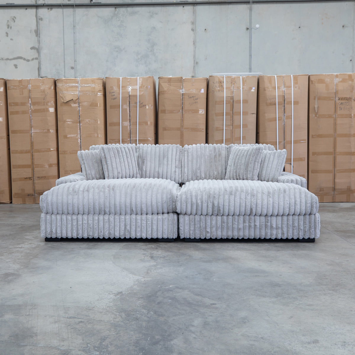 The Kalena Oversized Plush Feather & Foam Double Chaise Lounge - Silver available to purchase from Warehouse Furniture Clearance at our next sale event.