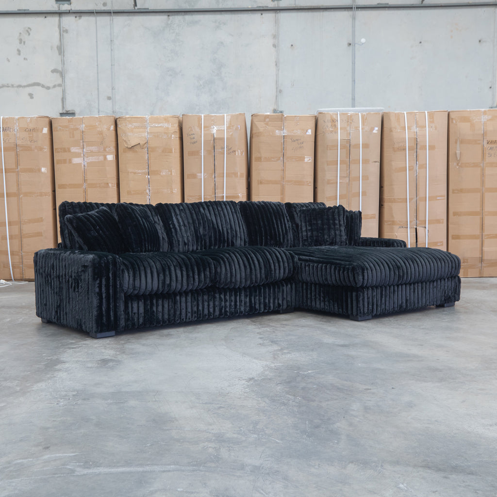 The Kalena Oversized Plush Feather & Foam RHF Chaise Lounge - Black available to purchase from Warehouse Furniture Clearance at our next sale event.