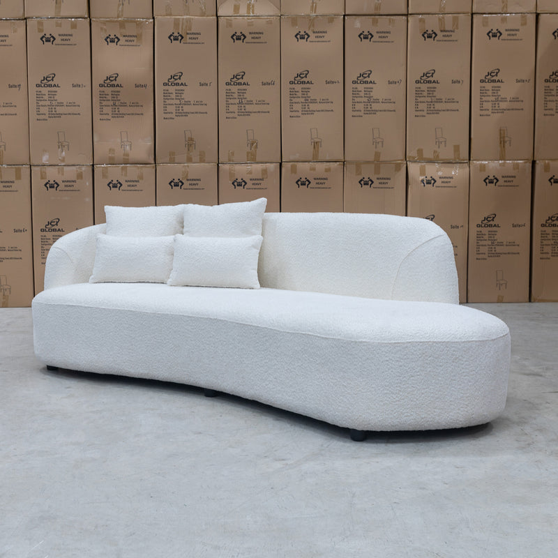 The Santorini Curved Chaise Sofa - Ivory Boucle available to purchase from Warehouse Furniture Clearance at our next sale event.