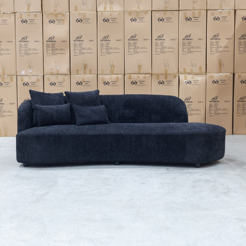 The Santorini Curved Boucle Chaise - Black Boucle Fabric available to purchase from Warehouse Furniture Clearance at our next sale event.